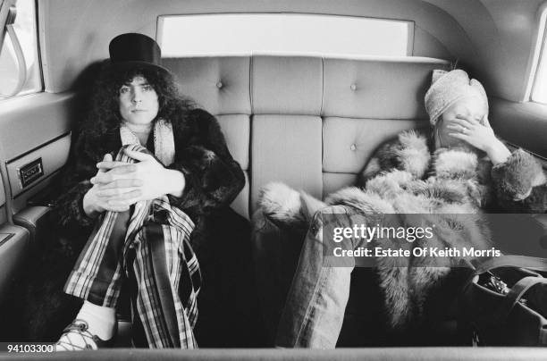 Singer Marc Bolan of English glam rock group T-Rex, in a limousine with his wife June Child during a US tour, 1971.