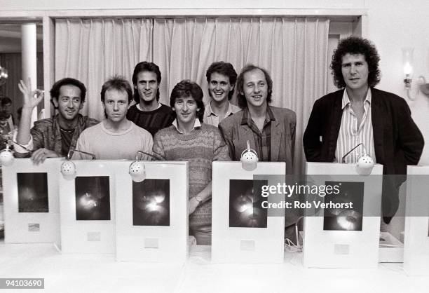 Dire Straits pose with their awards for the best selling compact disc in Holland, in Rotterdam on May 25 1985. L-R Jack Sonni, Alan Clark, Chris...