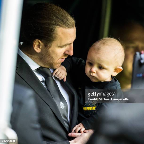 Former AIK captain Nils-Eric Johansson holds his son before an Allsvenskan match between AIK and Dalkurd FF at Friends arena on April 2, 2018 in...