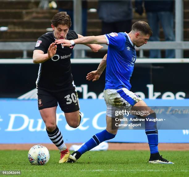 Lincoln City's Alex Woodyard vies for possession with Carlisle United's Mike Jones during the Sky Bet League Two match between Carlisle United and...