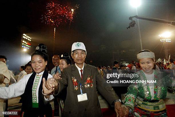 Dien Bien Phu veteran dances with ethnic minority women during a ceremony to mark the 50th anniversary of Dien Bien Phu battle at the North-Western...