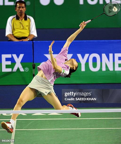 Wong Mew Choo of Malaysia reaches for the shuttlecock to return to Juliane Schenk of Germany during women's singles final at the Badminton World...