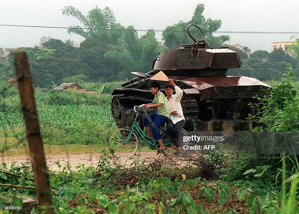 A girl shields her friend from the rain