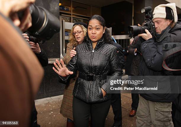 Attorney General Baroness Scotland's former cleaner Loloahi Tapu gestures to photographers as she leaves Westminster Magistrates Court on December 7,...