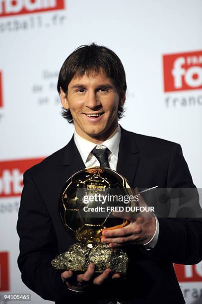 Barcelona's Argentinian forward Lionel Messi holds his trophy after receiving the European footballer of the year award, the "Ballon d'Or" , on...