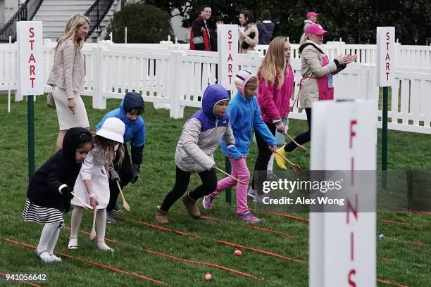 Children roll eggs during the 140th annual Easter Egg Roll on the South Lawn of the White House April 2, 2018 in Washington, DC. The White House said...