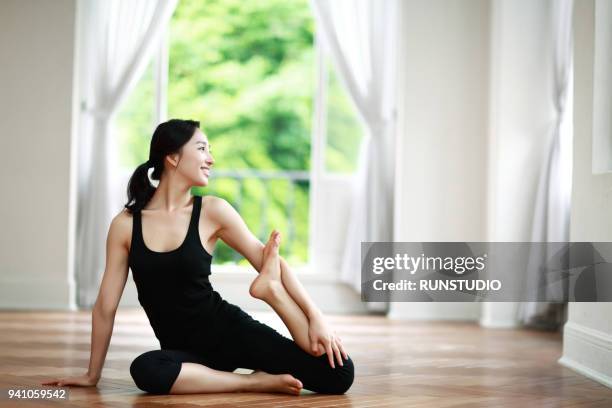 young woman  doing yoga in living room - this morning 2017 ストックフォトと画像