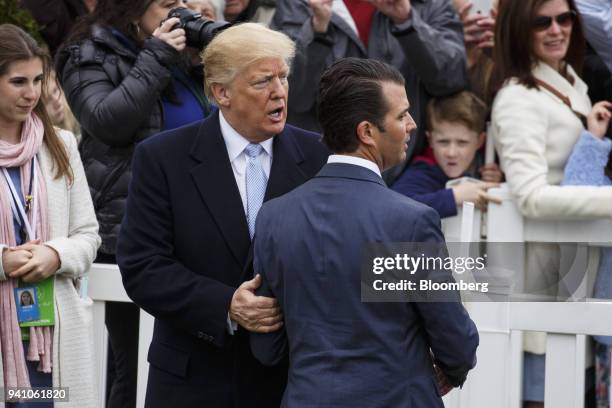 President Donald Trump, center left, speaks with son Donald Trump Jr., executive vice president of development and acquisitions with the Trump...