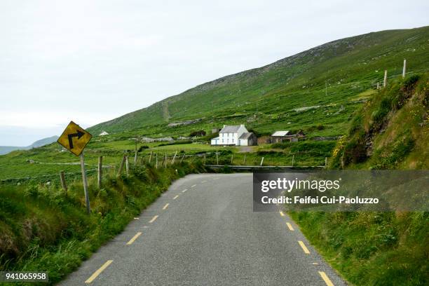 winding road and sign near dingle, county kerry, ireland - dingle ireland stock pictures, royalty-free photos & images