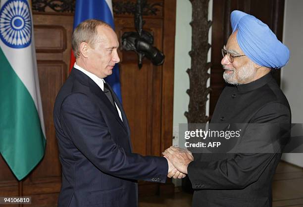 Indian Prime Minister Manmohan Singh shakes hands with Russian Prime Minister Vladimir Putin during their meeting in Moscow on December 7, 2009....