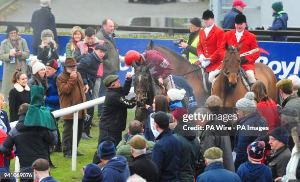 Jockey J J Slevin on board General Principle, celebrates with Uncle Jim O'Brien, watched by cousins Joseph and Sara o'Brien after winning the...