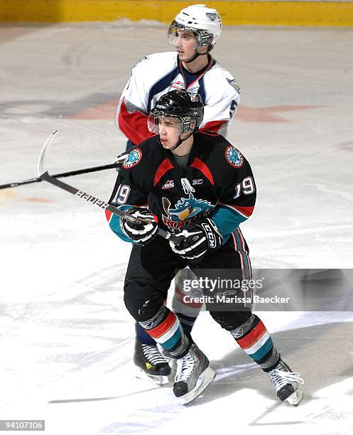 Brett Bulmer of the Kelowna Rockets is checked Eric Mestery of the Tri-City Americans at Prospera Place on December 5, 2009 in Kelowna, Canada.