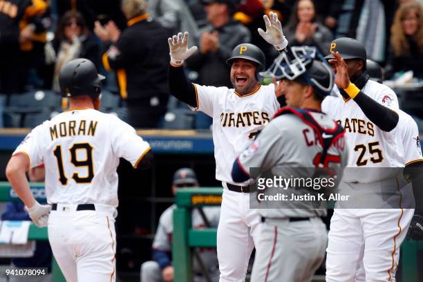 Francisco Cervelli of the Pittsburgh Pirates celebrates with Colin Moran who hit a grand slam home run in the first inning against the Minnesota...