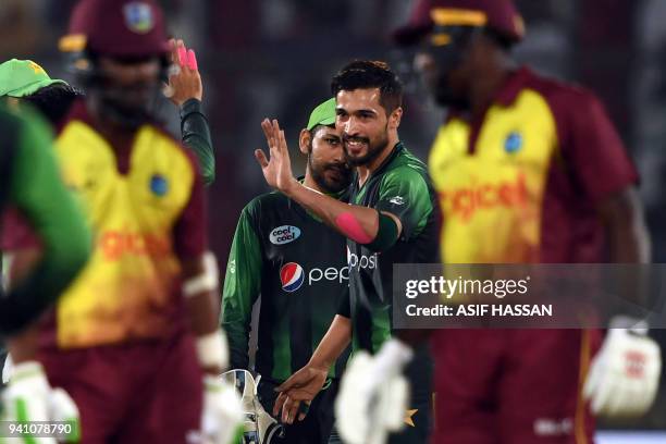 Pakistans' bowler Mohammad Amir celebrates with teammates after the taking the wicket of West Indies' captain Jason Mohammed during the second...