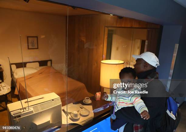 James Williams and his son, Conner Williams looks in at room 306 at the Lorraine Motel, where Dr. Martin Luther King, Jr. Stayed before he was...