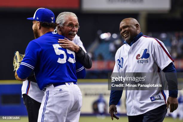 Former pitcher for the Montreal Expos Steve Rogers hugs it out with Russell Martin of the Toronto Blue Jays while former left fielder for the...