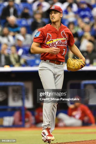 Luke Weaver of the St. Louis Cardinals looks on after throwing a pitch against the Toronto Blue Jays during the MLB preseason game at Olympic Stadium...