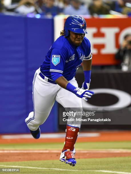 Vladimir Guerrero Jr. #27 of the Toronto Blue Jays runs towards first base against the St. Louis Cardinals during the MLB preseason game at Olympic...