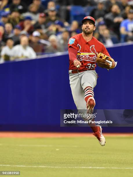 Greg Garcia of the St. Louis Cardinals throws the ball against the Toronto Blue Jays during the MLB preseason game at Olympic Stadium on March 27,...
