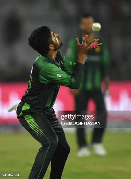 Pakistan's cricketer Babar Azam takes a catch of West Indies' batsman Rovman Powell during the second Twenty20 International cricket match between...