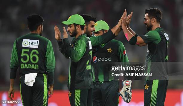 Pakistans' cricketers celebrate after the dismissal of West Indies' batsman Rovman Powell during the second Twenty20 International cricket match...