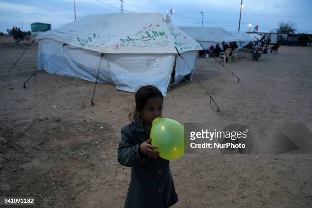 Palestinian Girl Play next to tents on April 2, 2018 along the border with Israel east of Gaza City during a tent protest in support of Palestinian...