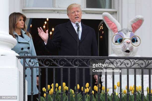 President Donald Trump speaks as First Lady Melania Trump listens during the Easter Egg Roll on the South Lawn of the White House in Washington,...
