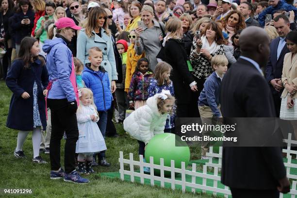 First Lady Melania Trump, left, watches as children participate in activities during the Easter Egg Roll on the South Lawn of the White House in...