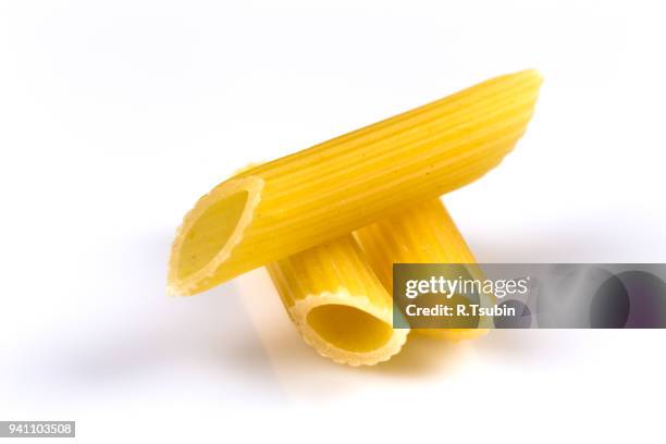 uncooked italian penne pasta - penne stockfoto's en -beelden