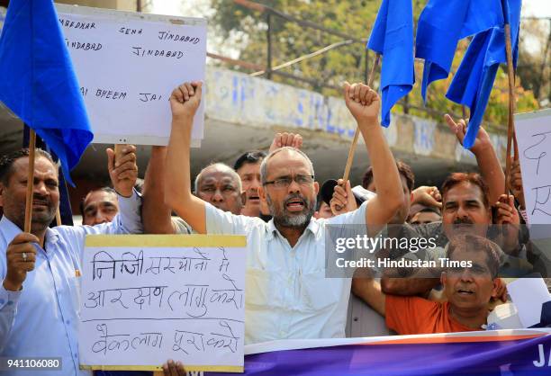 Bahujan Samaj Party supporters holding placards as they shout slogans during a nationwide strike, on April 2, 2018 in Jammu, India. Nine people were...