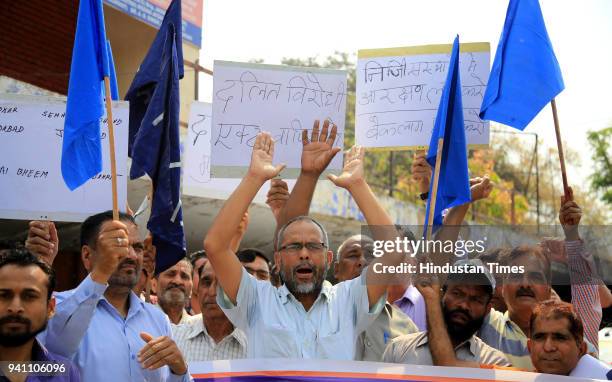 Bahujan Samaj Party supporters holding placards as they shout slogans during a nationwide strike, on April 2, 2018 in Jammu, India. Nine people were...