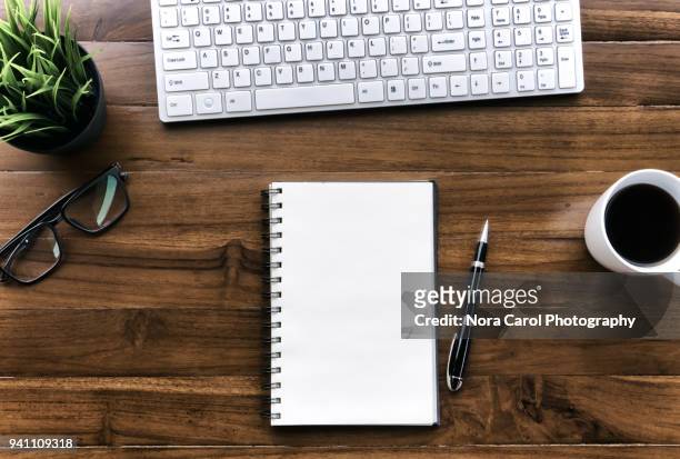top view of workspace wood table - notepad table stock pictures, royalty-free photos & images
