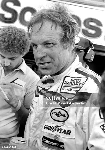 Driver Joe Ruttman talks with reporters after competing in the 1983 Daytona 500 stock car race at Daytona International Speedway in Daytona Beach,...