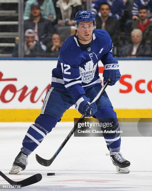 Tyler Bozak of the Toronto Maple Leafs skates with the puck against the Winnipeg Jets during an NHL game at the Air Canada Centre on March 31, 2018...