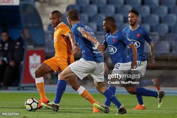 Porto's Algerian forward Yacine Brahimi vies with Belenenses's defender Goncalo Silva , Belenenses's forward Fredy of Angola and Belenenses's...