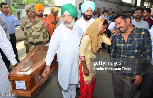 Seema weeping bitterly to see the coffins of her husband Sonu which was brought from Iraq at Sri Guru Ram Dass Jee International Airport on April 2,...