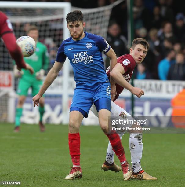 Jack Baldwin of Peterborough Utd clears the ball from Chis Long of Northampton Town during the Sky Bet League One match between Peterborough United...