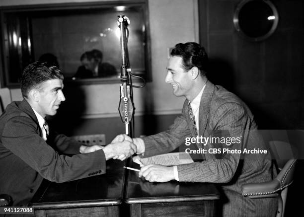 Professional baseball players Carl Hubbell of the New York Giants, and Lou Gehrig of the New York Yankees are photographed in a studio while...