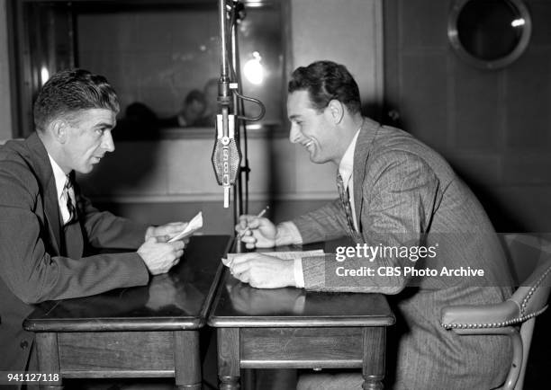 Professional baseball players Carl Hubbell of the New York Giants, and Lou Gehrig of the New York Yankees are photographed in a studio while...