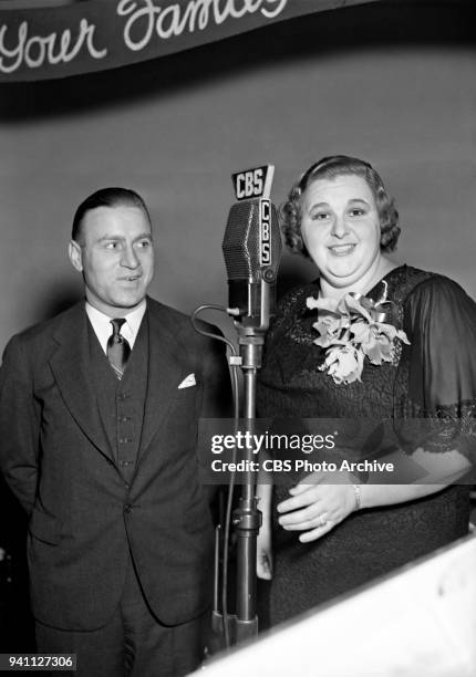 Guest John Clipper Smith, head football coach at Duquesne University poses for a photo with Kate Smith on the Kate Smith Hour radio program, also...