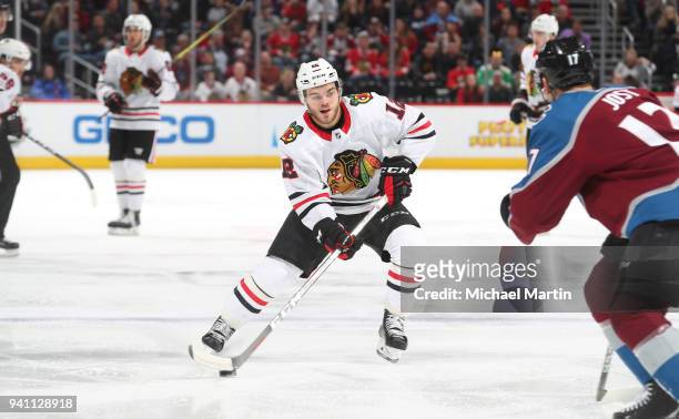 Alex DeBrincat of the Chicago Blackhawks skates with the puck against the Colorado Avalanche at the Pepsi Center on March 30, 2018 in Denver,...