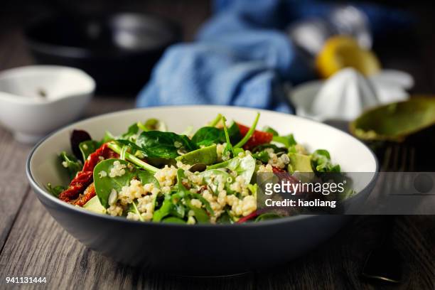 healthy vegan quinoa spinach salad - salad bowl stock pictures, royalty-free photos & images