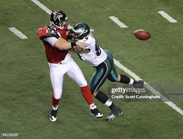 Chris Redman of the Atlanta Falcons passes against Jason Babin of the Philadelphia Eagles at the Georgia Dome on December 6, 2009 in Atlanta,...