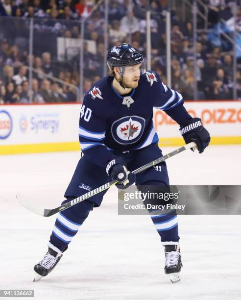 Joel Armia of the Winnipeg Jets keeps an eye on the play during second period action against the Boston Bruins at the Bell MTS Place on March 27,...