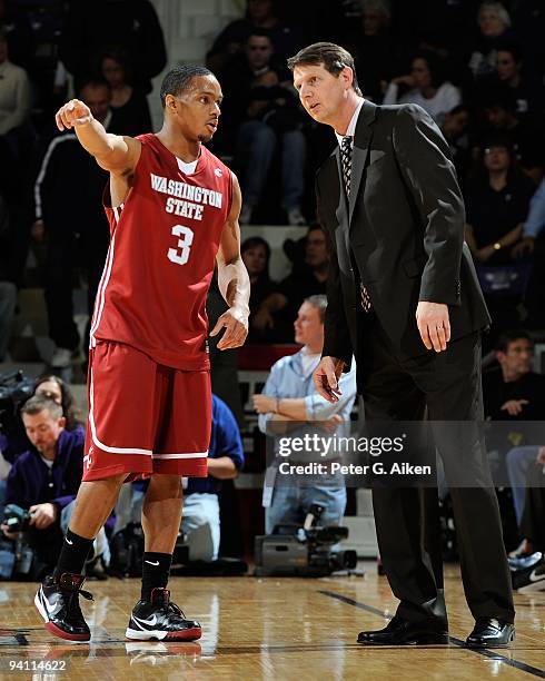 Guard Reggie Moore of the Washington State Cougars talks with head coach Ken Bone against the Kansas State Wildcats in the first half on December 5,...