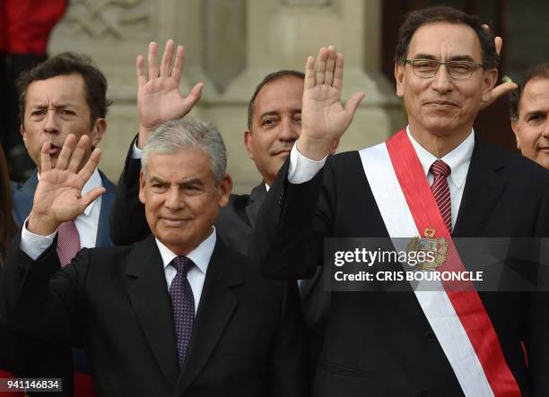 Peruvian President Martin Vizcarra and his new Chief of Staff Cesar Villanueva wave during a ceremony in which eighteen new ministers were sworn in,...