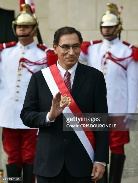 Peruvian President Martin Vizcarra waves during a ceremony in which eighteen new ministers were sworn in, at the main courtyard of the Palace of...