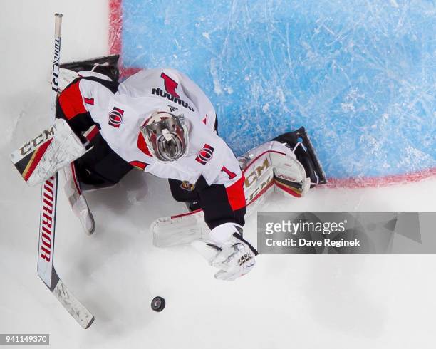 Mike Condon of the Ottawa Senators makes a glove save against the Detroit Red Wings during an NHL game at Little Caesars Arena on March 31, 2018 in...