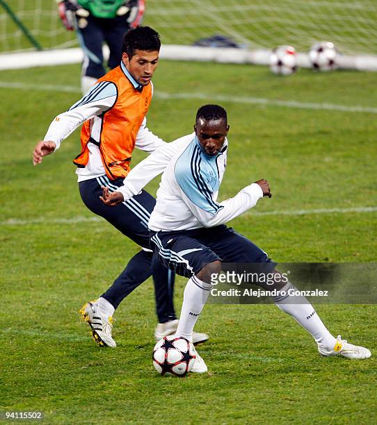 Mahamadou Diarra and Ezequiel Garay of Real Madrid in action during a training session at Velodrome stadium on December 7, 2009 in Marseille, France.
