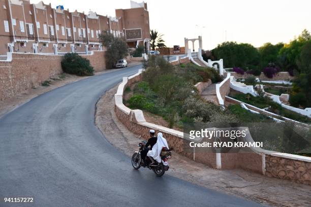 Algerians ride a motorbike on the road leading to Ksar Tafilelt, which is self-proclaimed as the first eco-friendly town of Algeria, near Ghardaia,...